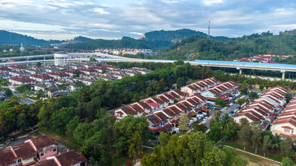 Aerial view of residential area with green asphalt road and residential houses directly above viewpoint. View of suburbs and city district. Real estate and housing market concept. - 601572639