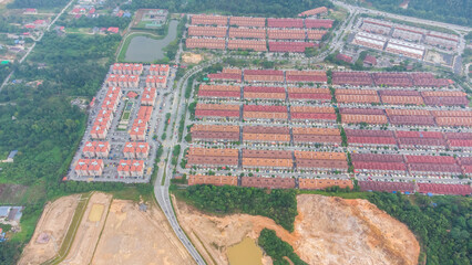 Aerial view of residential area with green asphalt road and residential houses directly above viewpoint. View of suburbs and city district. Real estate and housing market concept. - 601572669