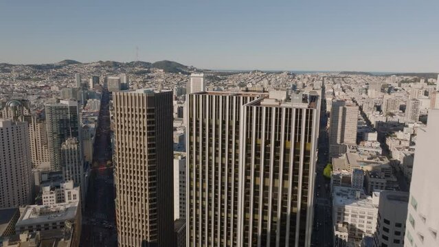 Fly over high rise downtown office buildings. Revealing aerial view of Union Square with famous Westin St Francis hotel. San Francisco, California, USA