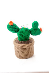 pincushion in the shape of a cactus in a pot, crocheted, on a white background