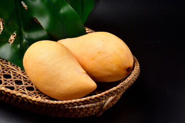 Fresh Thai Mango.Barracuda mango on the wicker basket. Food and drink concept. Thai Fruits Summer...