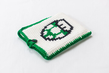 envelope for external hard drive, crocheted with a green mushroom drawn