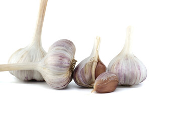 Garlic bulbs and cloves in close-up on white