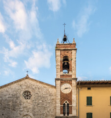Fototapeta na wymiar Bell Tower of San Francesco church in the medieval village of San Quirico d'Orcia, Tuscany region in central Italy, Europe