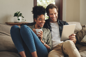 Relax, home and interracial couple on a couch, tablet and happiness with social media and connection. Partners, man and woman on a sofa, technology and loving with a smile, romance and online reading - obrazy, fototapety, plakaty