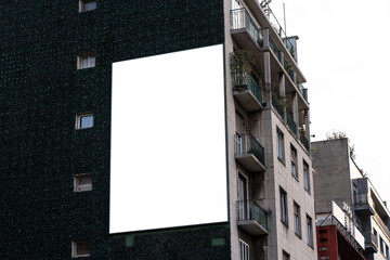 Large screen advertisement in Milan on a residential building wall.