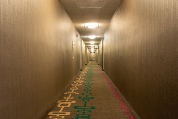 Empty Hotel Corridor Lit with Lighting Fixtures