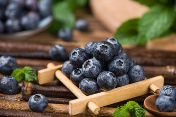 fresh blueberry fruit on wooden table.