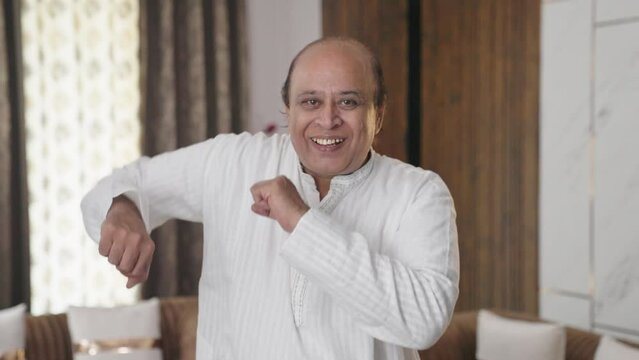 Happy Indian old uncle dancing and enjoying