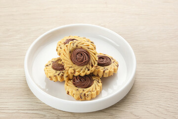 Chocolate Butter Cookies, popular cookies for Eid celebrations in Indonesia. Served in white plate 
