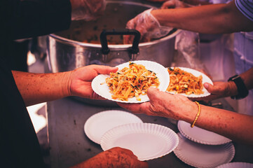 Volunteers offer free food to the poor: the concept of food sharing.