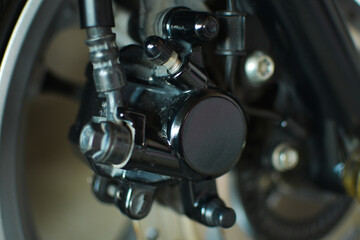 Fototapeta na wymiar Detail photo caliper rear brake system motorcycle. part of motorcycle. Motorcycle equipment 