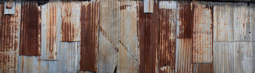 Background made of rusted iron sheet metal and corrugated iron which are fastened together....