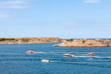 Fototapeta na wymiar Leisure boats in a rocky archipelago in summer