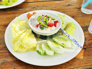 Thai food Simmer crab dip is serving with fresh vegetables, cucumbers, carrot and cabbages. It is said to be a clean, healthy and low calories food