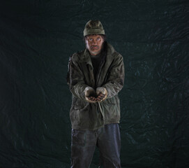 dirty homeless man beggar on dirty background