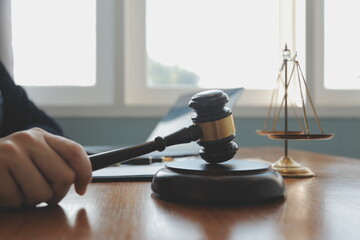 Business and lawyers discussing contract papers with brass scale on desk in office. Law, legal...