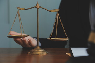 Business and lawyers discussing contract papers with brass scale on desk in office. Law, legal...