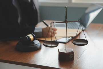 Business and lawyers discussing contract papers with brass scale on desk in office. Law, legal...