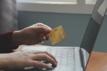 Close up of woman hand using credit card and laptop for payment and online shopping, Online...