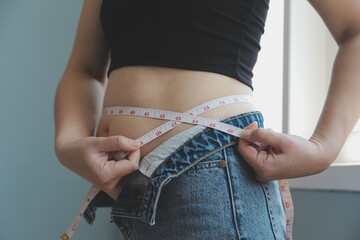 fat woman, fat belly, chubby, obese woman hand holding excessive belly fat with measure tape, woman...