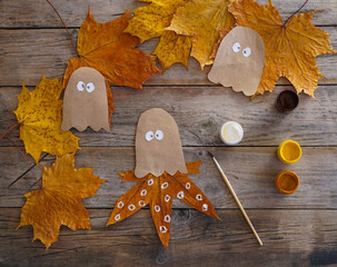 A child makes an octopus craft from autumn leaves and kraft paper. Step by step instruction - 4