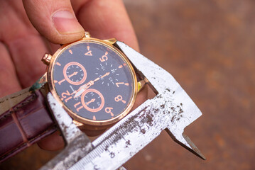 time measurement concept moving, watch ticking metal shtangel carefully measures the desired part...