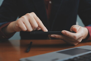 Asian Businesswoman Using laptop computer and working at office with calculator document on desk, doing planning analyzing the financial report, business plan investment, finance analysis concept.