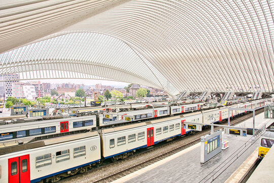 Indoor scene of the SNCB NMBS Train station of liege guillemins with railroad platforms and trains waiting for departure