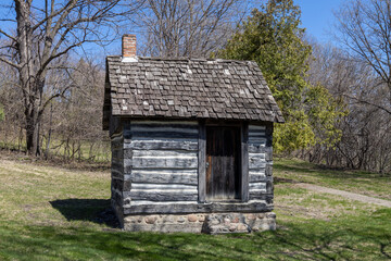 Rustic 19th century single room log cabin located in a rural area in the midwestern United States
