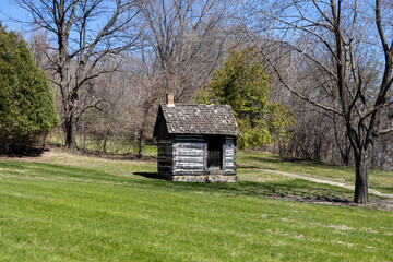 Plakat Rustic 19th century single room log cabin located in a rural area in the midwestern United States 