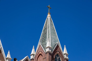 Upward view of a steeple tower on a 19th century American church with a Gothic Revival style...