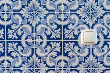 Tapeten Portuguese traditional tiles background. Retro old vintage wall blue tiles. House in Portugal interior style hydraulic ceramic mosaic tiles. © Joao