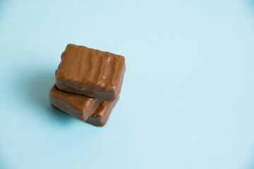 Delicious chocolate candies on a blue paper background