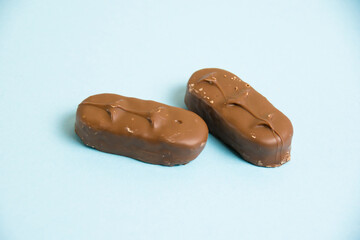 Delicious chocolate bars on a blue background