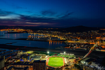 Sunset over Gibraltar town and  and Spanish town of La Linea de la Concepcion across the Bay of Gibraltar, UK