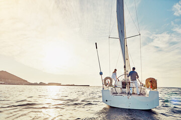 Couple, yacht or sailing on vacation for adventure at sea with sun and waves to relax in summer....