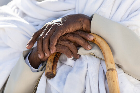 Elderly Ethiopian man's hands and cane
