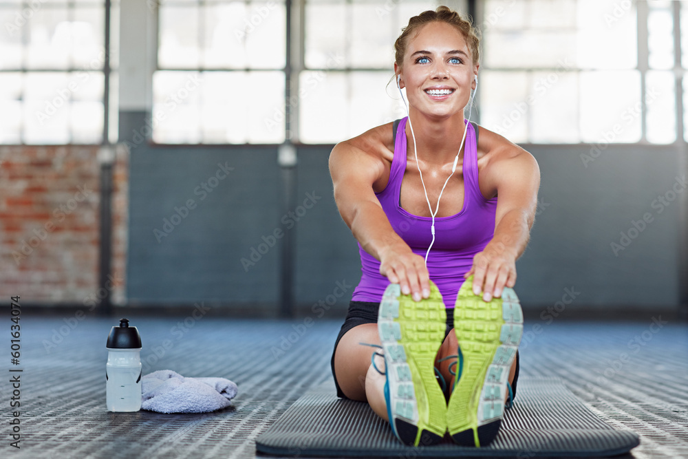 Poster Thinking, fitness and music with a woman stretching in a gym while getting ready for her workout routine. Exercise, warm up and earphones with a young female athlete training in a sports center