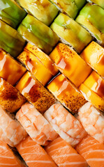 Set of colorful rolls with shrimp, salmon, avocado, cheese, close-up top view.