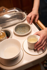 Masseuse hands prepping for ayurvedic massage session