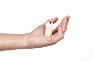 Men's hand holding a candle isolated white background. Man holding burning candle, closeup
