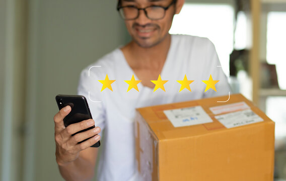 man recieved parcel and happy with choosing five stars on smartphone for review packing and delivery 
