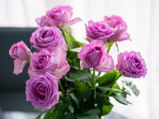 Bouquet of pink roses by a window. Light and airy look. selective focus. Expression of love concept.