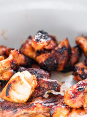 Properly cooked small chicken portions in a white bowl. Sumer picnic food concept. Barbeque season time. Food to share.