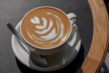 Cappuccino and delicious whipped creme dessert on wooden table in cafe. Mockup for cafe or restaurant with copy space.