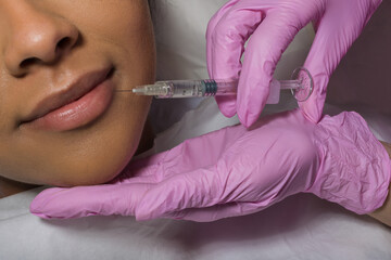 Young Woman Receiving lips Injection In Beauty Clinic