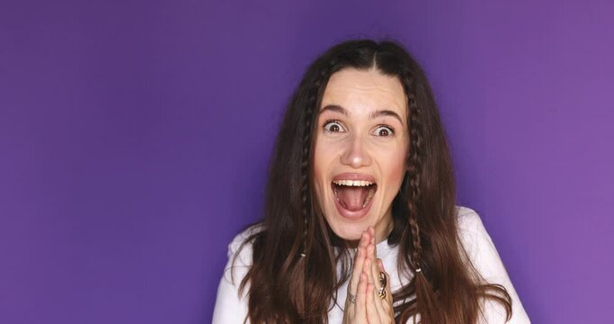 Excited happy fun young woman with braids wear white t-shirt scream hot news about sales discount with hands near mouth hurry up isolated on plain purple background studio portrait.