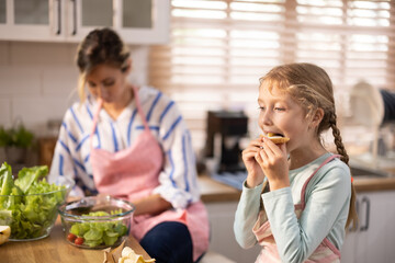 Multi-generational family members explore new and tasteful recipes on a tablet, make healthy food...