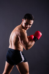 Fototapeta na wymiar Professional athlete boxer in red gloves who isolated on studio. Sport, competition concept.
